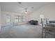 Bright living room with large windows, ceiling fan, and neutral carpet flooring at 7292 Sherman Hills Blvd, Brooksville, FL 34602