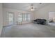 Bright living room with a sliding glass door to the outside, a ceiling fan, and neutral flooring, offering a versatile living space at 7292 Sherman Hills Blvd, Brooksville, FL 34602