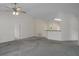 Spacious living room featuring neutral paint, a ceiling fan, and easy access to other areas in the home at 7292 Sherman Hills Blvd, Brooksville, FL 34602