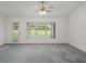Living room with an exit door and a window showing a view of the golf course at 7292 Sherman Hills Blvd, Brooksville, FL 34602
