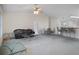 Open-concept living room with high ceilings, a ceiling fan, a large comfortable couch and an eating area with barstool seating at 7292 Sherman Hills Blvd, Brooksville, FL 34602