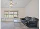 Bright living room with a sliding glass door to the outside, a ceiling fan, and neutral flooring, offering a versatile living space at 7292 Sherman Hills Blvd, Brooksville, FL 34602
