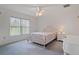 Bright main bedroom with a ceiling fan, large window, and neutral carpet, creating a cozy retreat at 7292 Sherman Hills Blvd, Brooksville, FL 34602