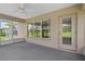 Relaxing screened-in patio with outdoor ceiling fan and views of the well-maintained lawn at 7292 Sherman Hills Blvd, Brooksville, FL 34602