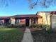 Inviting front exterior view of the home, featuring a well-manicured lawn, walkway, and vibrant landscaping at 7523 Greystone Dr # 35, Hudson, FL 34667