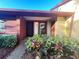 Charming front entrance with colorful landscaping leading to the front door of the house at 7523 Greystone Dr # 35, Hudson, FL 34667