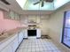 Functional kitchen space with white cabinets and ample counter space, bathed in natural light at 7523 Greystone Dr # 35, Hudson, FL 34667