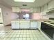Open-concept kitchen featuring a breakfast bar overlooking the living spaces, awaiting transformation at 7523 Greystone Dr # 35, Hudson, FL 34667