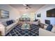 Cozy living room with stylish furniture and decor, seamlessly flowing into the dining area and kitchen at 7523 Greystone Dr # 35, Hudson, FL 34667