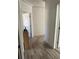 Hallway with laminate flooring leading to various rooms at 7715 Chasco St, Port Richey, FL 34668