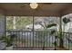 View of screened-in patio with ceiling fan, exterior view, and various green plants at 7828 Hardwick Dr # 922, New Port Richey, FL 34653