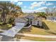 Inviting exterior showcasing a well-maintained lawn, a two car garage and mature landscaping at 7842 Leighton Cir, New Port Richey, FL 34654