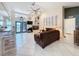 Bright living room featuring tile floors, high ceilings, fireplace, and access to the porch at 8032 Spring Hill Dr, Spring Hill, FL 34606