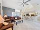 View of living room with tile floors, vaulted ceilings and view to kitchen with bar top and seating at 8032 Spring Hill Dr, Spring Hill, FL 34606