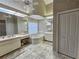 Elegant bathroom with a soaking tub, dual sinks, and ample counter space at 8157 Hidden Hills Dr, Spring Hill, FL 34606