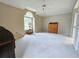 Large bedroom with ceiling fan, vaulted ceiling, and a large window at 8157 Hidden Hills Dr, Spring Hill, FL 34606