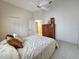 Carpeted bedroom with a ceiling fan, closet, and a connecting door at 8157 Hidden Hills Dr, Spring Hill, FL 34606