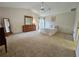Spacious main bedroom featuring neutral carpet, high ceilings, and plenty of natural light at 8157 Hidden Hills Dr, Spring Hill, FL 34606