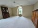 Large bedroom with ceiling fan, vaulted ceiling, and a large window at 8157 Hidden Hills Dr, Spring Hill, FL 34606