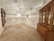 Traditional dining room featuring a wooden china cabinet, carpeted floor and pendant lighting at 8157 Hidden Hills Dr, Spring Hill, FL 34606