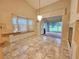 Open dining room with tile floors and natural light from windows overlooking backyard at 8157 Hidden Hills Dr, Spring Hill, FL 34606