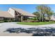 Attractive building exterior with stone accents, well-maintained landscaping, and mature trees on a sunny day at 8157 Hidden Hills Dr, Spring Hill, FL 34606