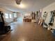 Large garage with epoxy floors, a work bench, and storage cabinets at 8157 Hidden Hills Dr, Spring Hill, FL 34606