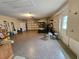 Spacious garage with epoxy floors, shelving, and a golf cart at 8157 Hidden Hills Dr, Spring Hill, FL 34606