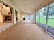 Enclosed lanai featuring ceiling fan and views of backyard at 8157 Hidden Hills Dr, Spring Hill, FL 34606