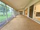 Large enclosed lanai with sliding glass doors and views of the backyard at 8157 Hidden Hills Dr, Spring Hill, FL 34606