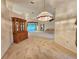 Open-concept living space with a china cabinet and view into the living room and backyard at 8157 Hidden Hills Dr, Spring Hill, FL 34606