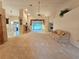 Open living room with a brick fireplace and large windows offering ample natural light at 8157 Hidden Hills Dr, Spring Hill, FL 34606