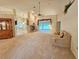 Spacious living room featuring a brick fireplace, ceiling fan and plush carpeting at 8157 Hidden Hills Dr, Spring Hill, FL 34606