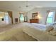 Carpeted main bedroom with neutral tones, high ceilings, and walk-in closet at 8157 Hidden Hills Dr, Spring Hill, FL 34606