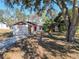 Front exterior view of home with two-car garage, stone accents and mature landscaping at 8157 Pagoda Dr, Spring Hill, FL 34606