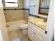 Bathroom with a tiled shower/tub, white vanity, and a granite countertop at 8514 Seeley Ln, Hudson, FL 34667