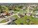 This is an aerial view of the neighborhood near a golf course and pond at 8983 Wade St, Brooksville, FL 34613