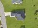 Aerial view of house showing new roof, landscaping and green lawn at 8983 Wade St, Brooksville, FL 34613