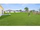 Large backyard with lush green grass and palm trees at 8983 Wade St, Brooksville, FL 34613