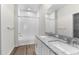 Bathroom with double sinks, granite countertops, and tub with white subway tile surround at 8983 Wade St, Brooksville, FL 34613