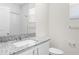 Modern bathroom with granite countertop, white cabinetry and good lighting at 8983 Wade St, Brooksville, FL 34613