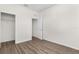 This is a bedroom with wood floors and a door to the closet and another room at 8983 Wade St, Brooksville, FL 34613