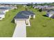 Well maintained home with a two-car garage, lush green lawn and mature trees at 8983 Wade St, Brooksville, FL 34613