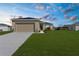 Charming single-story home showcasing a well-manicured lawn, neutral color palette, and attached garage at 8983 Wade St, Brooksville, FL 34613
