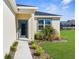 Charming home entrance with neat landscaping and a modern front door at 8983 Wade St, Brooksville, FL 34613