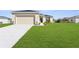 Landscaped front yard with lush green grass and a well-maintained home exterior at 8983 Wade St, Brooksville, FL 34613
