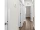 Hallway with wood-look flooring and white trim at 8983 Wade St, Brooksville, FL 34613