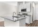 Kitchen island with granite countertops and stainless steel appliances at 8983 Wade St, Brooksville, FL 34613