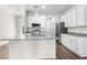 Bright open kitchen features white cabinetry, stainless appliances, and granite countertops at 8983 Wade St, Brooksville, FL 34613