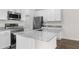 Bright kitchen with white cabinets, granite countertops, stainless steel appliances, and a center island at 8983 Wade St, Brooksville, FL 34613